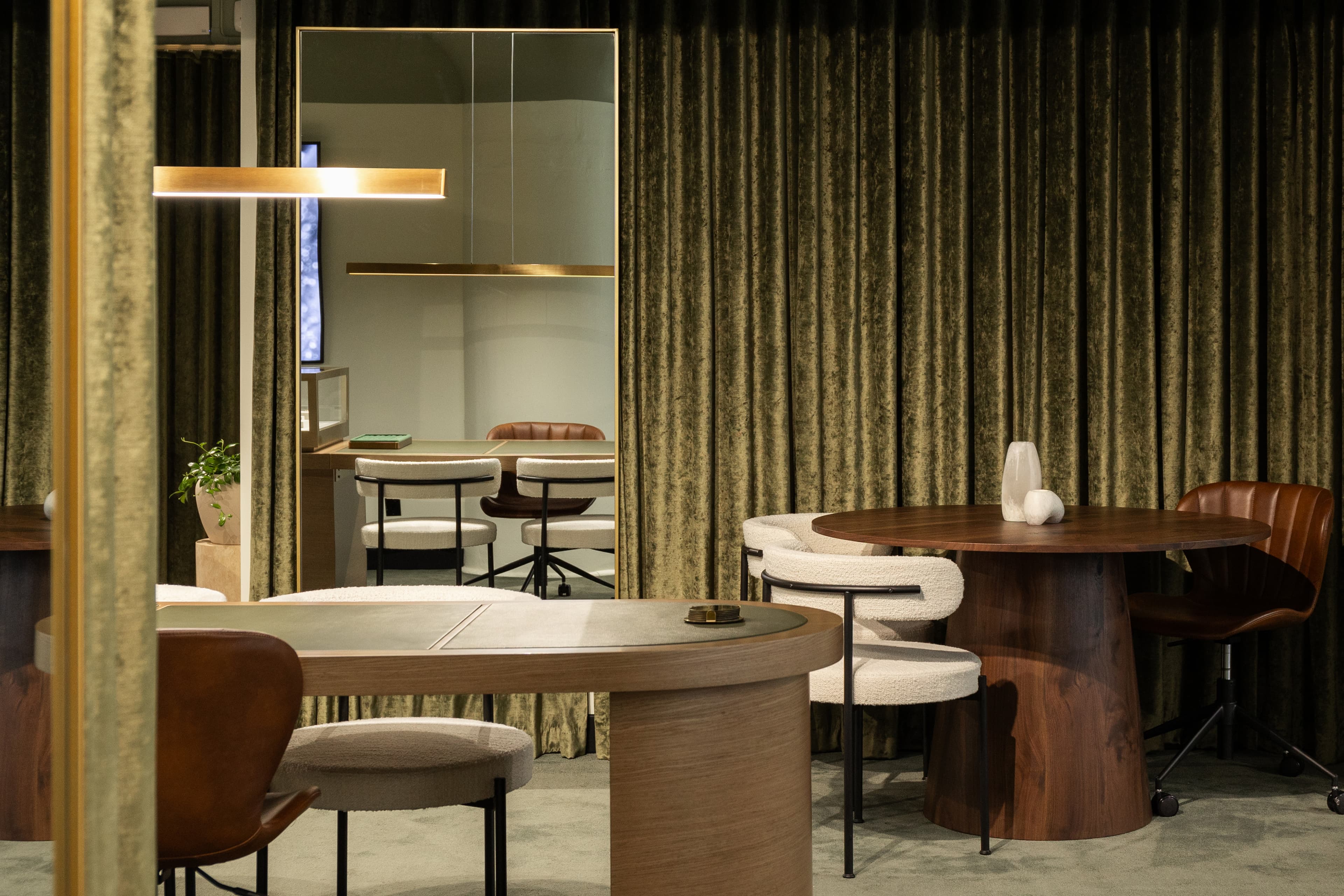 Cullen Jewellery interior detail — pendant lighting, brass-framed mirror, walnut joinery and olive velvet drapery in the appointment showroom